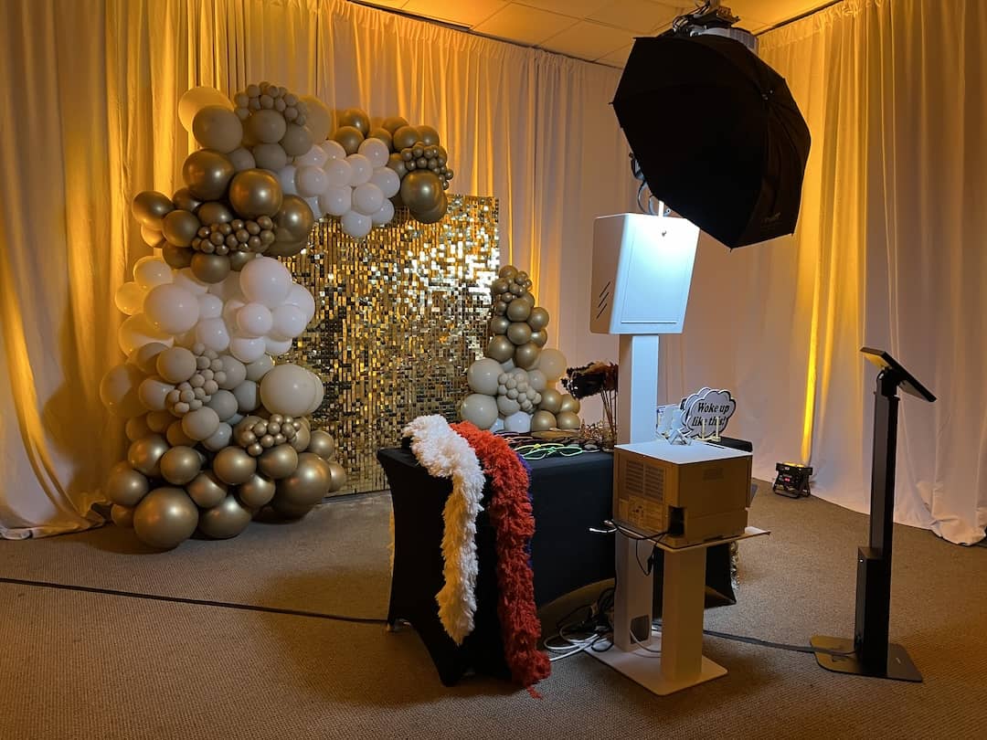 MN Booth Modern Photo Booth with professional lighting and a gold backdrop at an event